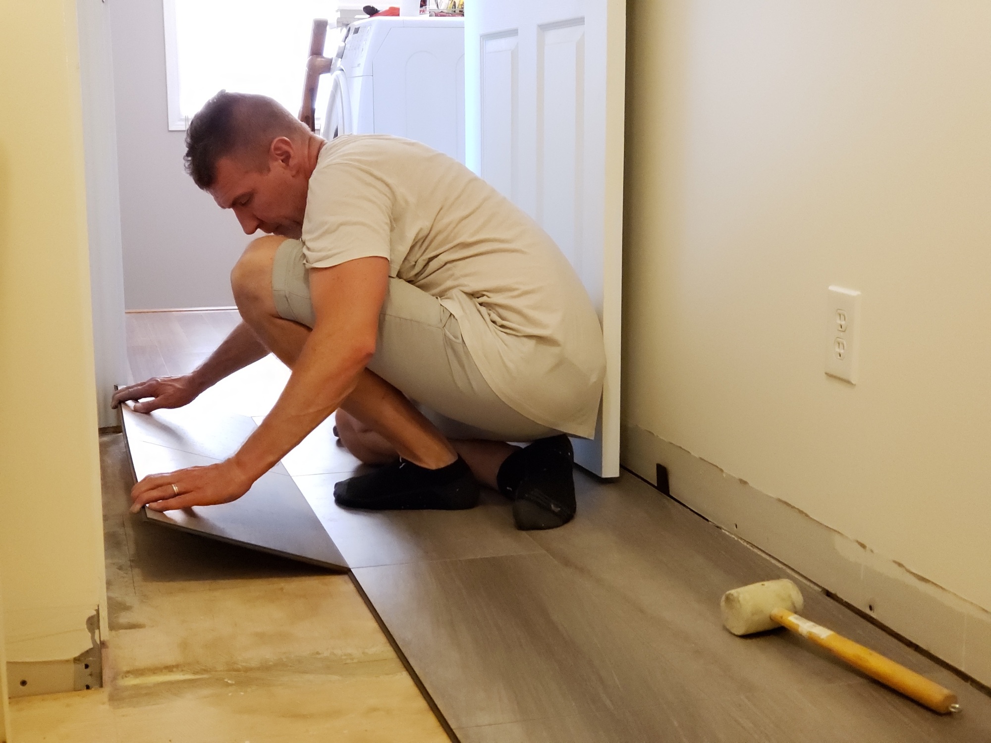 Floor level view of laminate flooring installation, home renovation, construction materials, tiles